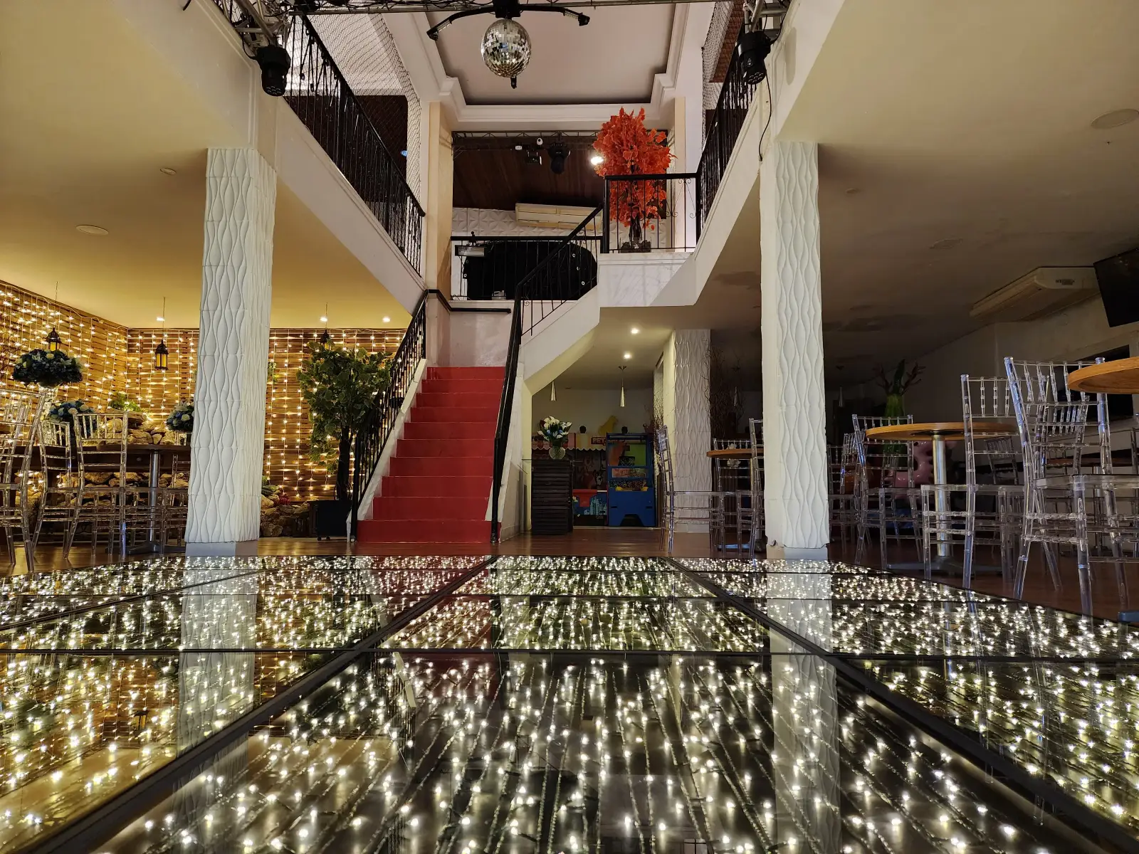 Salão com pista de dança espelhada iluminada