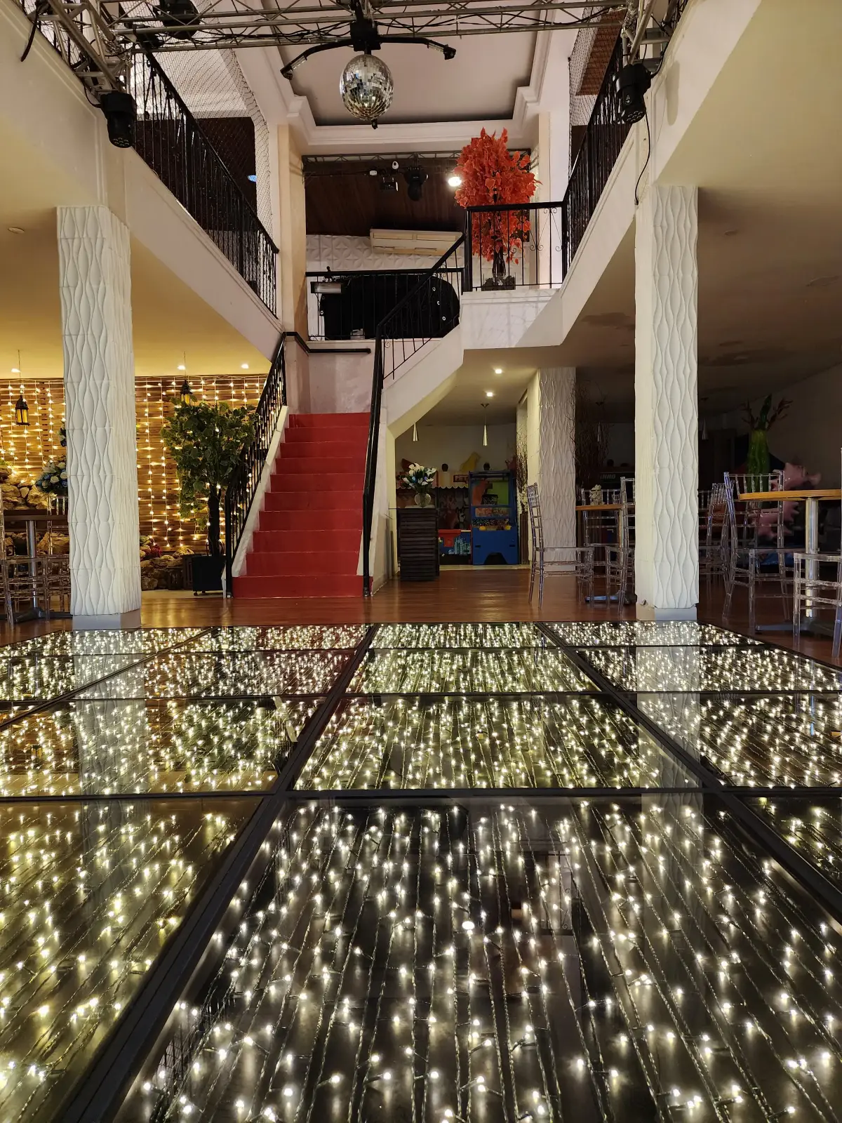 Pista de dança espelhada e escadaria com tapete vermelho